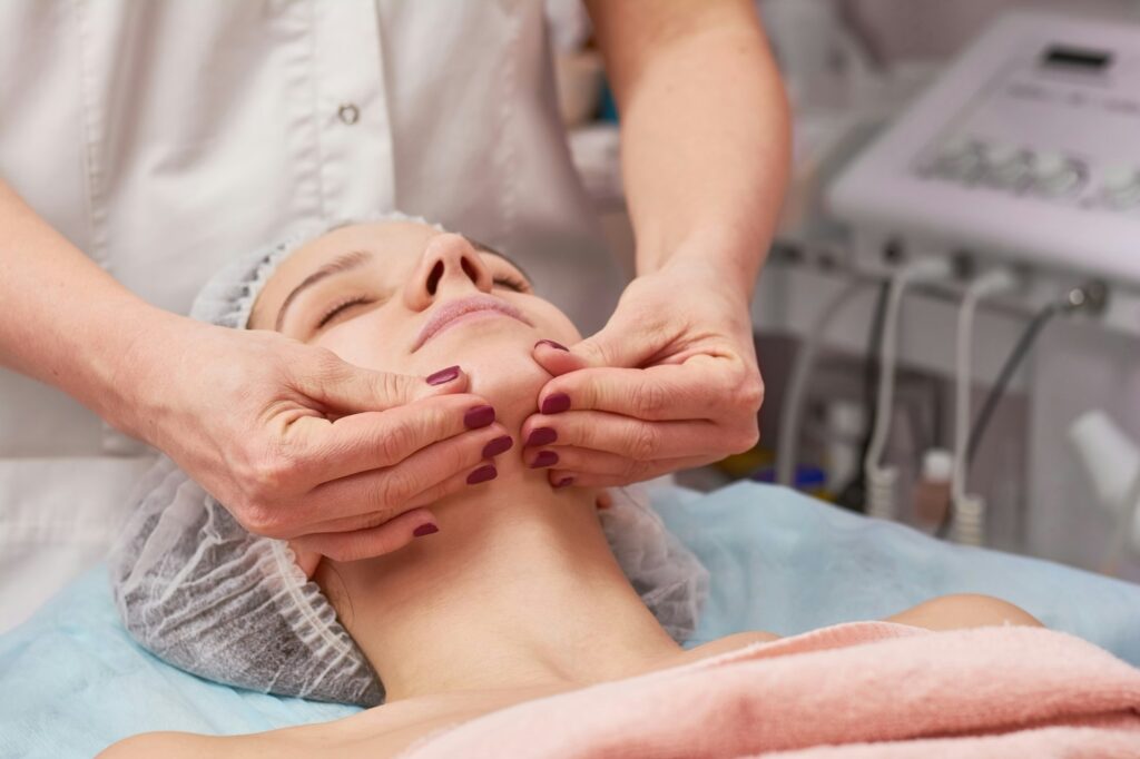 Hands massaging face